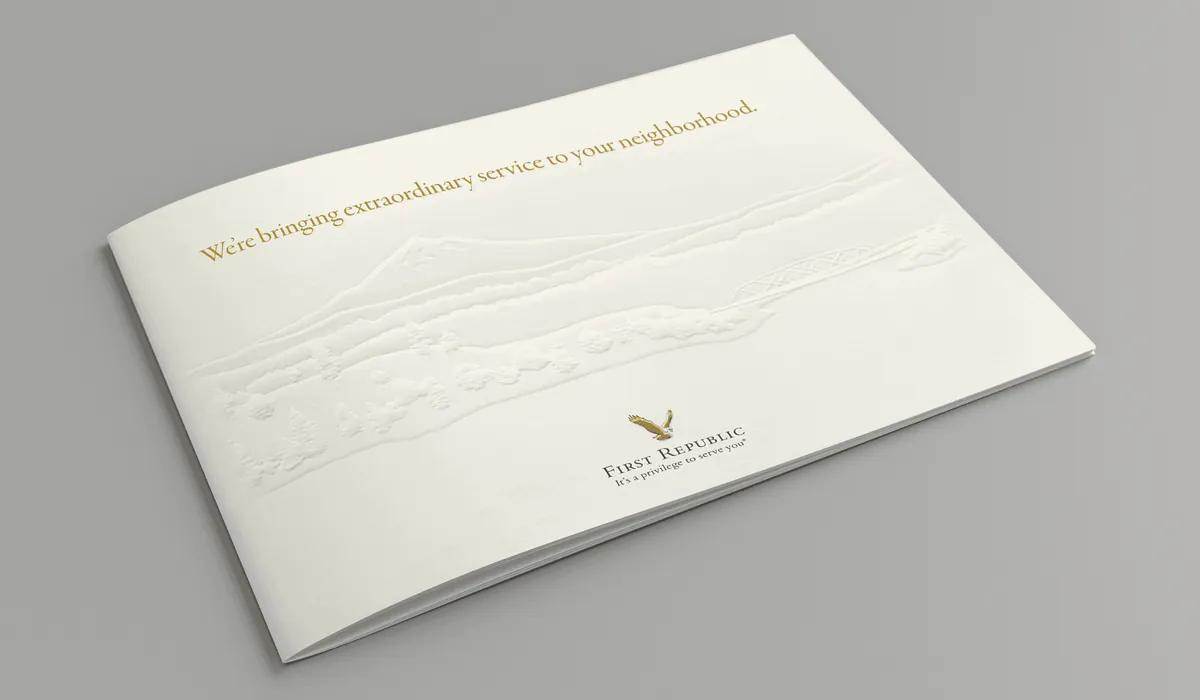 The mailer&rsquo;s cream cover, blind embossed, reading &ldquo;We&rsquo;re bringing extraordinary service to your neighborhood.&rdquo;
